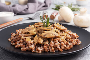 Boiled buckwheat with stewed mushrooms. Russian traditional food. Healthy diet food.