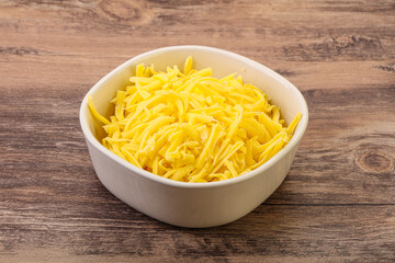 Shredded yellow cheese in the bowl