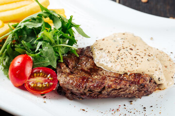 Closeup on fillet mignon steaks in a mushroom sauce with potatoes