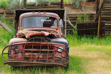 old abandoned red truck in a field