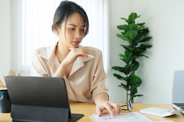 new normal, a businesswoman using  computer to work for a company Via the internet on your desk at home.