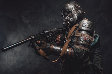 Stalker with custom armour and gun poses in dark background