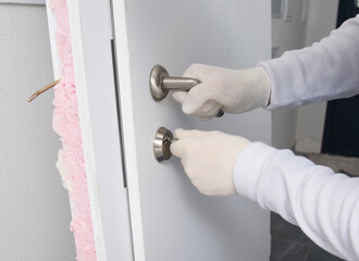 locksmith, trying to open the broken lock of the front door, after installation