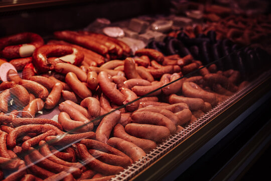 Refrigerated counter filled with quantity and different sausages