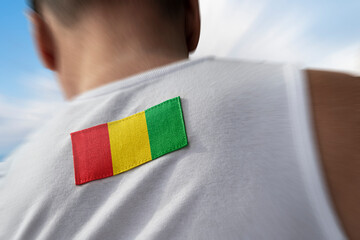 The national flag of Guinea on the athlete's back