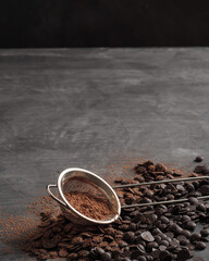 Chocolate chips, cocoa powder. Copy space. Vertical photo.