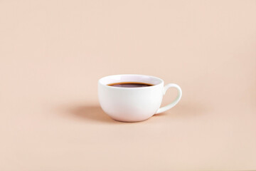 White cup with black coffee espresso on color background. Minimalism, Copy space for text.
