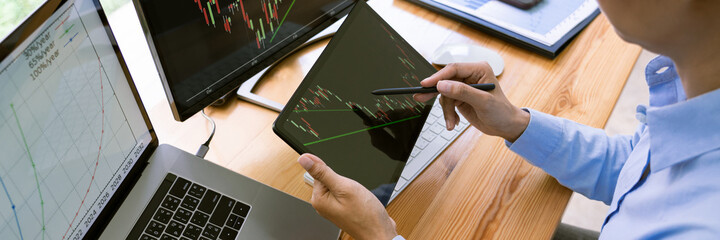 Stock Market Broker in formalwear Analyzing Graphs on  screens in the office, investment concept.