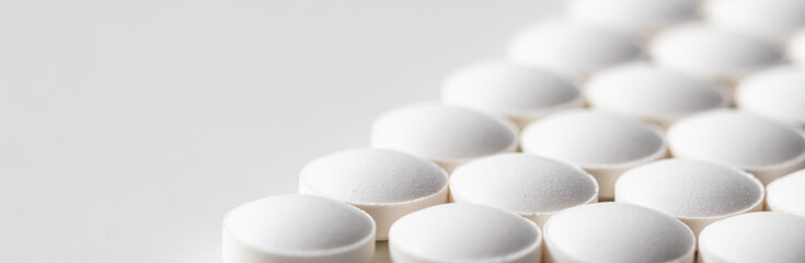 Rows of pills on a white background. Health care, medicine, pharmacy and disease concept