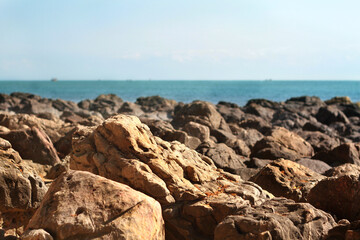 Fototapeta na wymiar Beach rocks, The sun shines against the rocks on the beach.