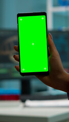 Chroma key isolated display on smartphone used by scientist woman in lab cabinet and colleagues in white coat bringing blood sample. Scientist using mobile phone with mockup green screen