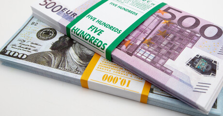 Bundle of dollars and euros on a white