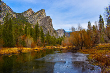 Beautiful Yosemite National Park Three Brothers mountain range with river and tall tress - Powered by Adobe
