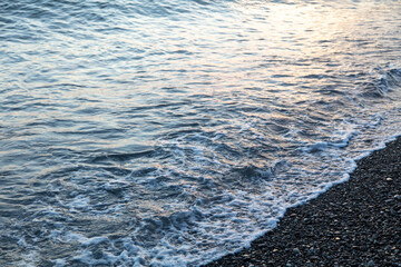 Water by the sea at sunset.