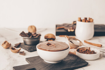 Bowl of tasty melted chocolate on grunge background