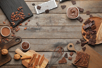 Frame made of different chocolate on wooden background