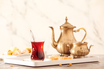 Composition with hot Turkish tea on light background