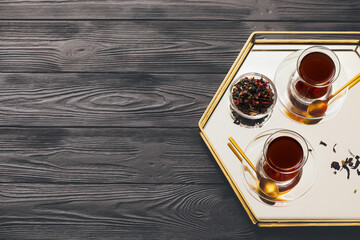 Cups with hot Turkish tea on dark wooden background