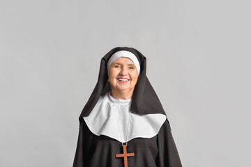 Senior nun on light background