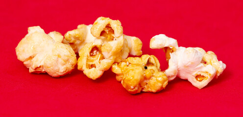 Close-up of popcorn on a red background.
