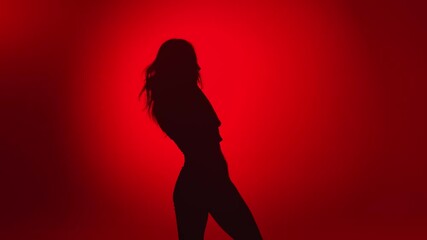 Seductive woman dancer shadow demonstrate dance movement isolated on red. Shot with RED camera in 4K - Powered by Adobe