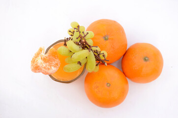 the healthy orange juice with green ripe grape , isolated on white background.
