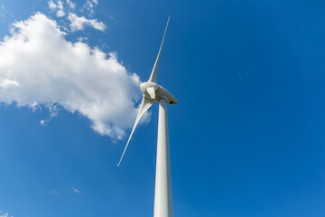 Detailed close up view of a wind turbine; generator, rotor and blade view