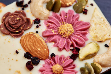 Obraz na płótnie Canvas Handmade white chocolate with dried fruits and nuts