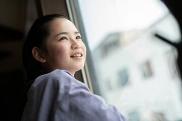 Girl Looking Out Window