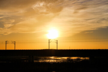 Idyllic sunset with yellow and orange colors and a lake in the background