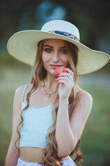 Young beautiful girl with peaches in hands in nature