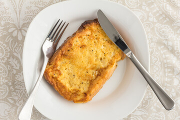 French toast with pepper and herbs - top view photo with knife and fork