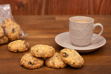 breakfast with a cup of coffee and cookies. Oatmeal cookies with raisins and nuts. homemade baking