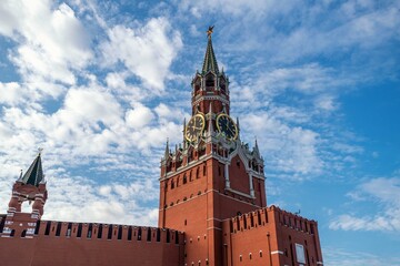 Fototapeta na wymiar Spasskaya tower with Kremlin chimes and walls of Kremlin in Moscow city in Russia on Red Square