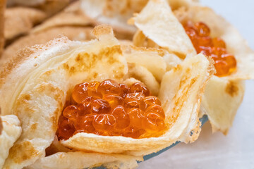 Homemade pancakes with red caviar.