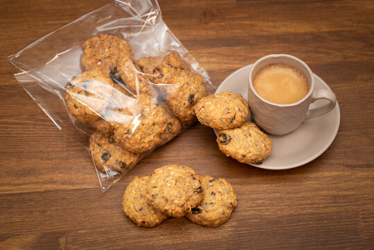 Homemade Oatmeal Cookies With A Cup Of Coffee On A Wooden Table Background. Healthy Food Snack Concept. View From Above