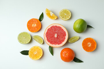 Fresh citrus with leaves on white background, top view