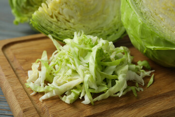 Board with fresh green cabbage on wooden background