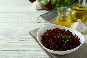 Concept of tasty eating with beet salad on white wooden background