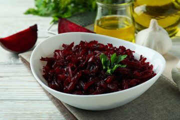 Concept of tasty eating with beet salad on white wooden background