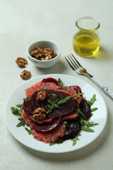 Concept of tasty eating with beet salad on white textured background