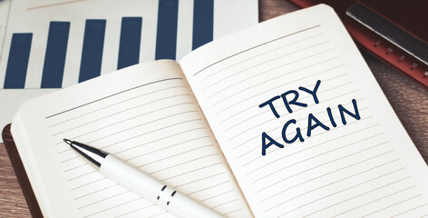 The words Try Again written on a white notebook. Work and study concept