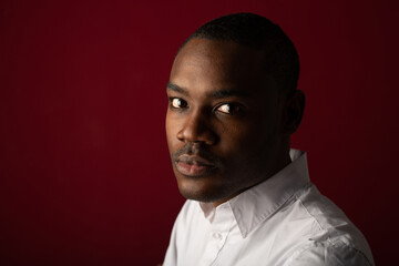 portrait of handsome young african man wearing white shirt 