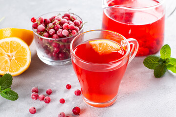 Berry tea with currants in cup on a light background. Vitamin drink, healthy food