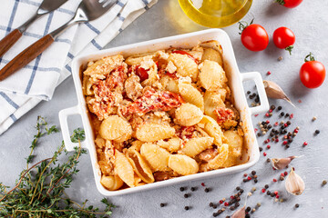 Step-by-step preparation and ingredients for oven-baked feta cheese with tomatoes and pasta, pepper garlic on a light background top view, mixing macaroni and cheese, trend recipe.