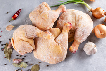 Frozen chicken legs on a light background. Raw chicken meat. Top view, copy space