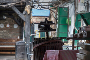 Vintage manual olive press at a farmstead backyard