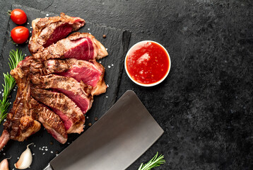 tomahawk beef steak grilled with spices on stone background with copy space for your text