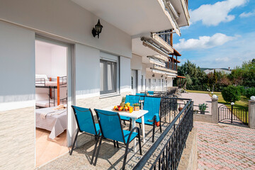 Summer garden view of modern studio room apartment with outside open terrace on white pavement floor in villa house backyard of Europe country resort hotel