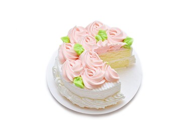 Cut cake decorated flowers, isolated on white background